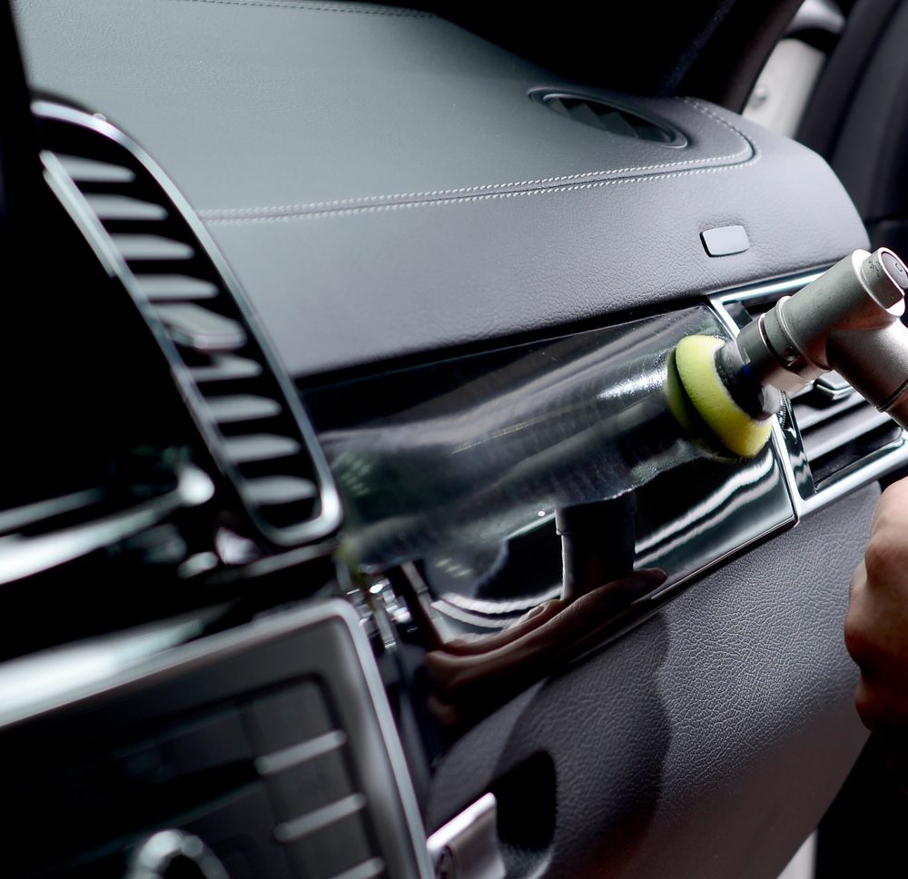 Polishing interior trim on a vehicle dashboard