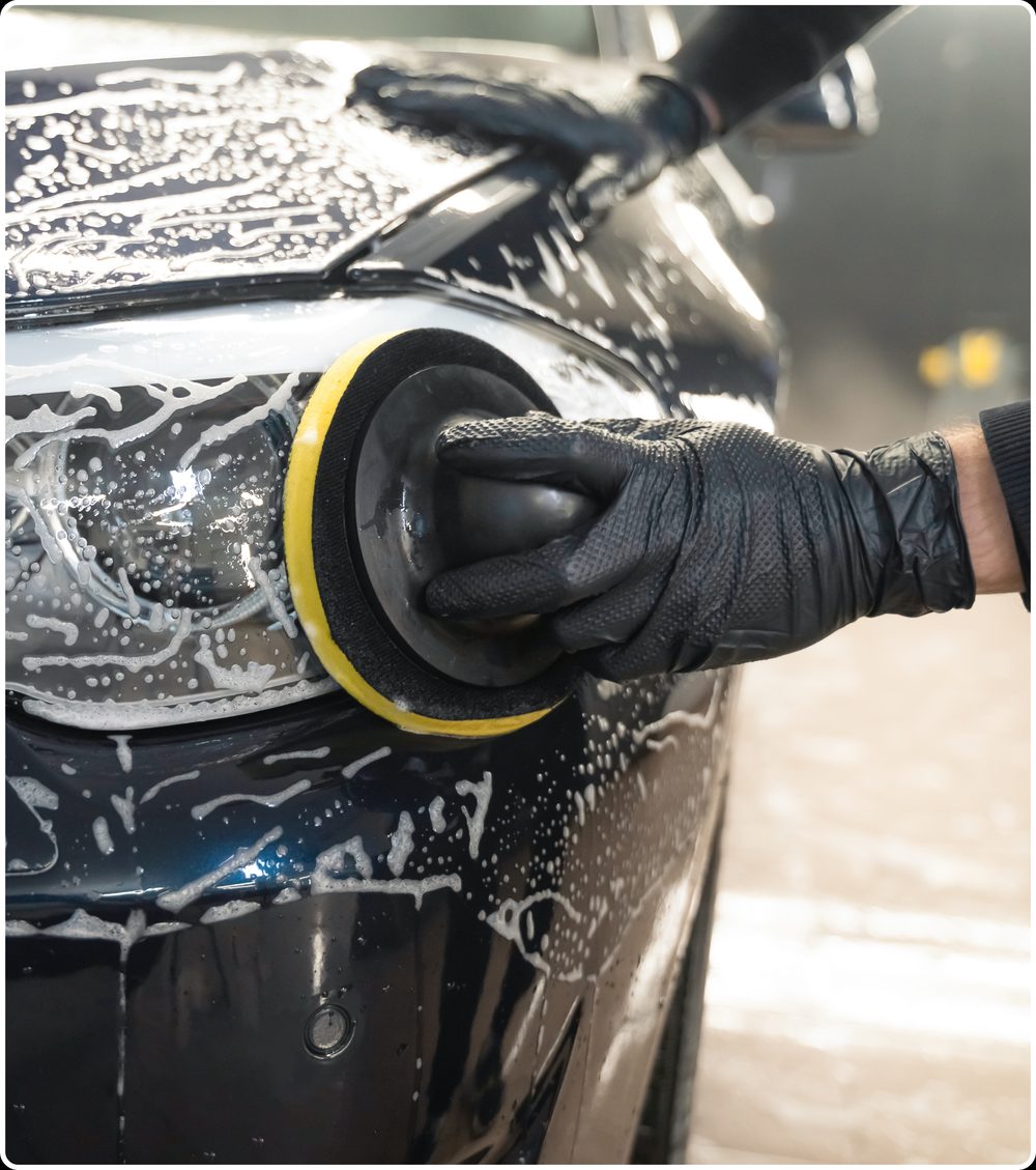 Buffing a headlight lens with a polishing pad